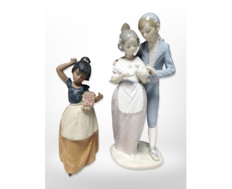 A Nao bisque porcelain figure of a girl carrying a basket of flowers, and another Nao group of a man and woman, tallest 32cm.