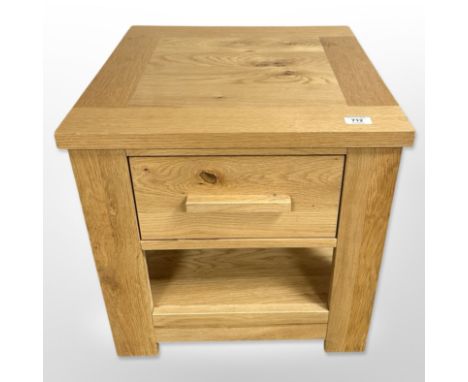 A contemporary light oak single-drawer lamp table, 50cm wide x 50cm high x 50cm deep.