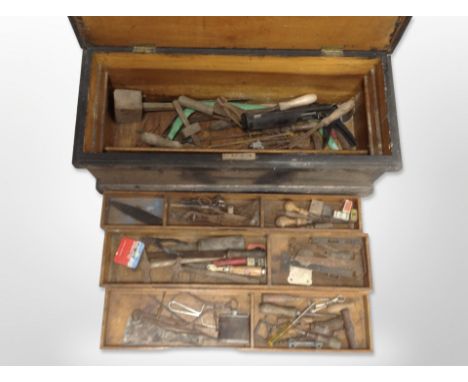 An antique pine joiner's tool box containing assorted carpentry tools 