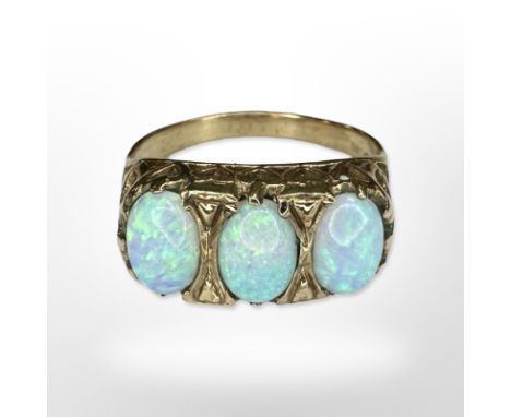 A 9ct yellow gold three stone opal ring, size O CONDITION REPORT: 3.2g.