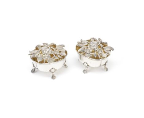 A pair of Swedish silver-gilt saltsC G Hallberg, 1905With open-work cast foliate hinged covers, lobed oval form on scroll fee
