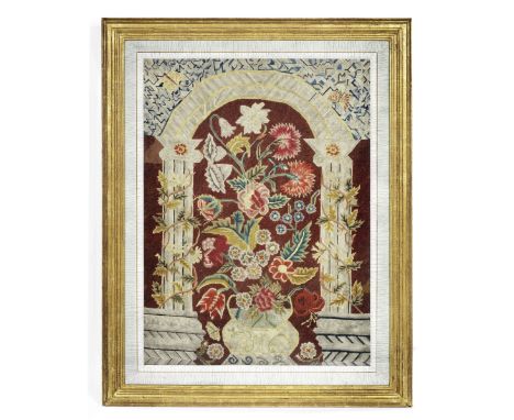 A good needlework panel depicting a vase of flowersprobably 18th century worked in petit point, the squat bulbous container s