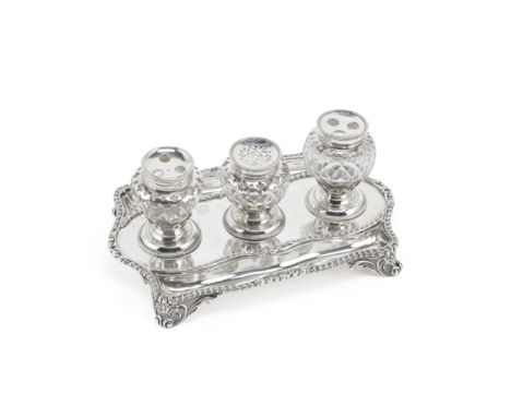 A George III silver inkstandEdward Aldridge, London 1765 Shaped-rectangular form, with gadroon borders and cut-glass bottles 
