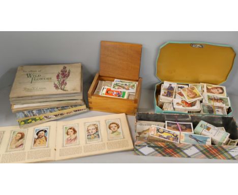 A collection of cigarette cards, tea card albums including 1930s football