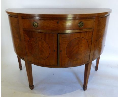 A 19th Century Mahogany Demilune Side Cabinet, The Cross-banded Top above a central drawer above two cupboards flanked by ova