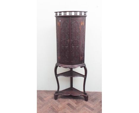 Late Victorian carved oak bow front corner cabinet standing on shelf style base 