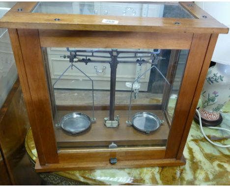 Set of laboratory scales in display case 