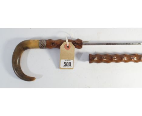 A silver mounted horn handle briar sword stick concealing a blade of 27.25" long the blade is marked Toledo  Condition : one 