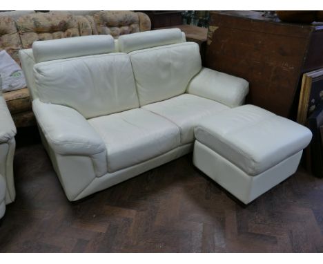 A modern 2 seater settee in off white leather with loose cushions and back pillows together with a matching pouffe