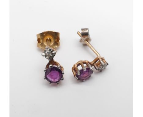Pair of diamond and ruby pierced ear studs on 9ct gold posts 
