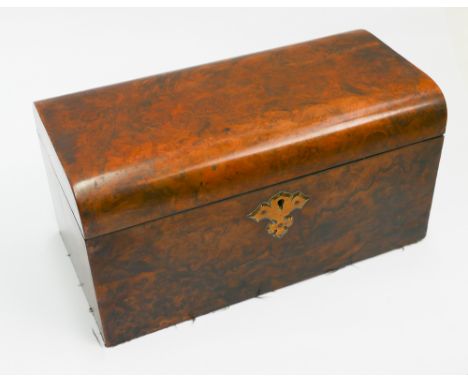 An early Victorian walnut rounded top tea caddy with interior fittings