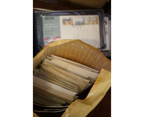 A Jiffy bag containing a large hoarde of UK First Day Covers, going back to 1967 at least, plus a blue stock book containing 