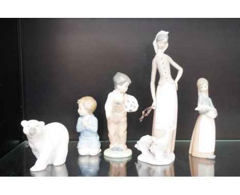 Three Lladro figurines together with to Nao figurines