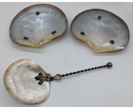 A small collection to include two Chinese mother of pearl dishes raised on three silver ball feet, and one mother of pearl sp