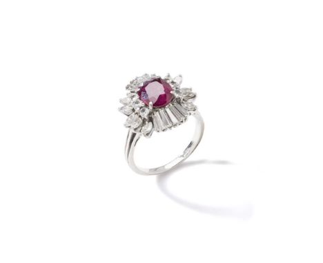 A ruby and diamond cluster ring The cushion-shaped ruby within a brilliant, marquise and tapered baguette-cut diamond surroun