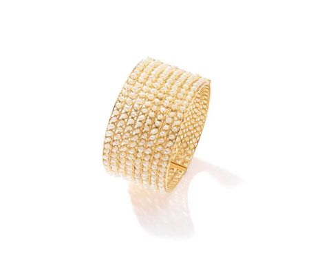 A seed pearl bangle The wide hinged bangle, set with eight rows of baroque seed pearlsDimensions:Inner diameter: 6.0cm