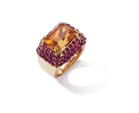 A citrine and ruby dress ring The rectangular scissor-cut citrine, within a tapered surround set with cabochon rubiesDimensio