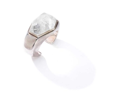 A rock crystal and silver bangle Collet-set with a fancy-shaped faceted rock crysatal, to a heavy torc bangle, UK hallmark, m