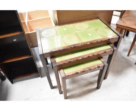 A vintage nest of three tile top tables, overall width 67cm
