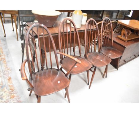 A set of four (three plus one) dark stained Ercol hoop and stick back chairs