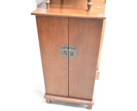 A modern mahogany CD cabinet having Oriental style handle