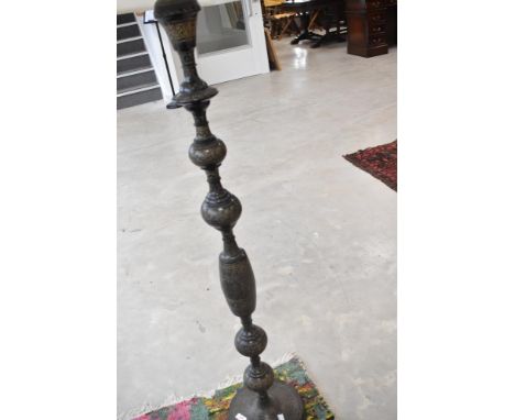 An Indian etched brass standard lamp, with modern cream shade