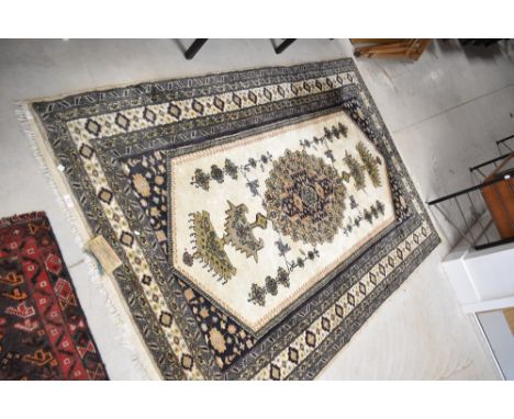 An Indian rug, bearing label for Oriental Carpet Factory, wool and silk, approx 6ft x 4ft