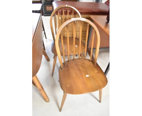 A pair of Ercol mid stain hoop and stick back dining chairs