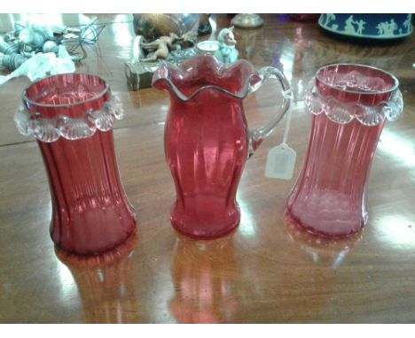 the flared bodies decorated with scallops, together with a ruby glass water jug