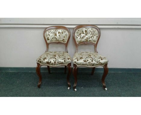 the balloon backs upholstered to match the tapestry seats supported by carved cabriole legs