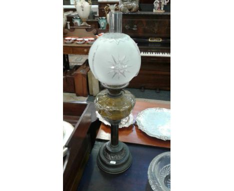 the shaped lamp with over painted reservoir held on a central column support