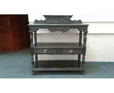 in the gothic revival style with a small carved back raised above a moulded&nbsp;rectangular top with scrolling carved frieze