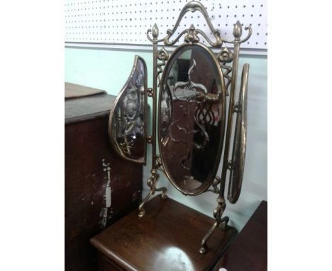 the tri-fold fire screen held within an Art Nouveau brass frame