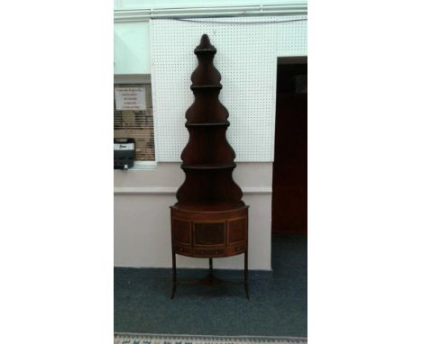 the upper section with graduated open shelves resting on an inlaid cabinet base with small central cupboard above a small dra