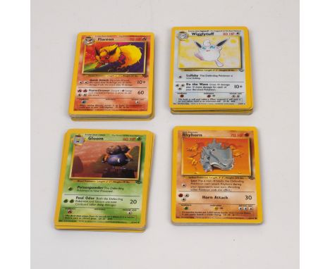 This lot contains 59 cards from the Jungle expansion, the second Pokemon set released in 1999. It includes 13 holographic car