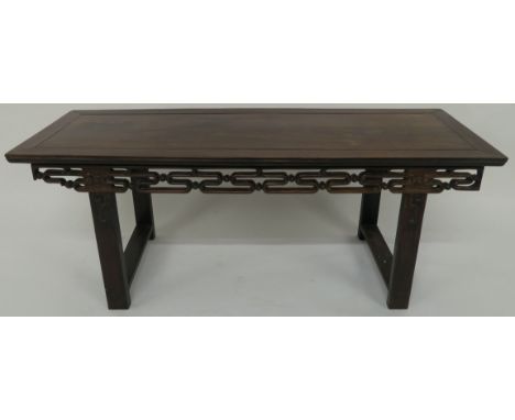 A CHINESE HARDWOOD ALTER TABLE the rectangular top above a scroll frieze on square legs joined by stretchers, 47cm high, 122c