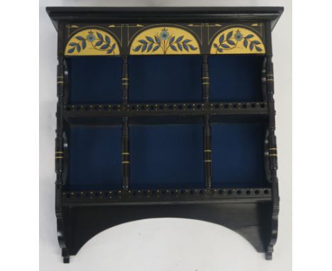 AN AESTHETIC MOVEMENT EBONISED AND PAINTED HANGING CABINET with three gilt and polychrome demilune panels above two tiers, jo