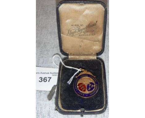 A 9CT AND ENAMEL JUNIOR CHAMPIONSHIP MEDAL, inscribed 'East Lancashire Cross Country Association'