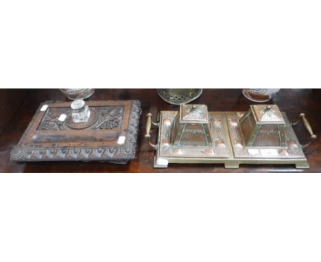AN ARTS & CRAFTS BRASS DOUBLE DESK INKWELL with hand-worked copper panels and lids and an oak inkwell