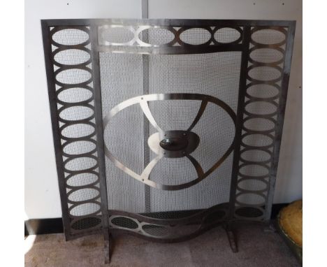 A MODERN STEEL FIREGUARD of serpentine form with smoky glass insert, 39" wide