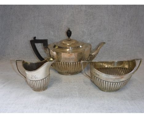 A THREE PIECE SILVER TEA SERVICE comprising teapot, sugar bowl and milk jug