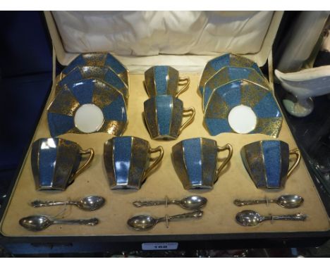 A PRESENTATION ROYAL DOULTON SIX PIECE SET OF CUPS AND SAUCERS and Mappin & Webb silver teaspoons