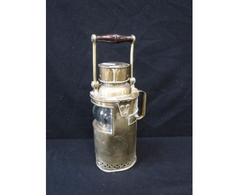 A BRASS MORSE CODE LANTERN with a swing handle, 13" high