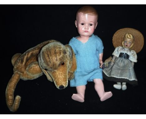A VINTAGE CELLULOID BOY DOLL, a Vintage plush pyjama case in the form of a dog and a felt doll (3)