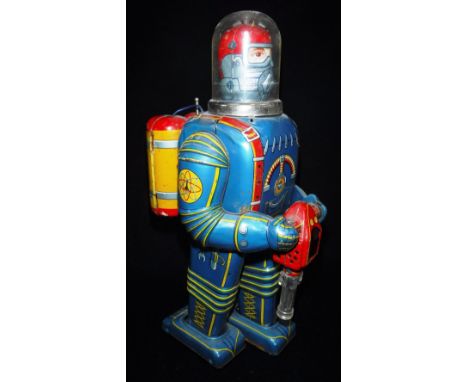 DAIYA: A VINTAGE JAPANESE TIN-PLATE BATTERY OPERATED SPACEMAN on wheels with ray-gun