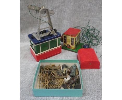 A VINTAGE TIN-PLATE BATTER OPERATED CABLE CAR and a quantity of metal farmyard figures