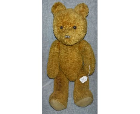 A LARGE VINTAGE TEDDY BEAR WITH JOINTED LIMBS