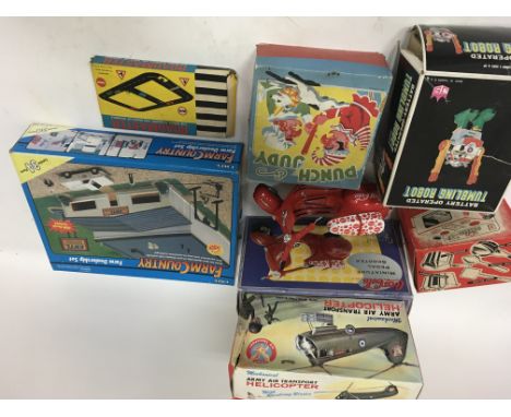 A collection of boxed toys including Coca Cola 1:6 scale scooter, ERTL Farm country , farm dealership set, Punch and Judy set