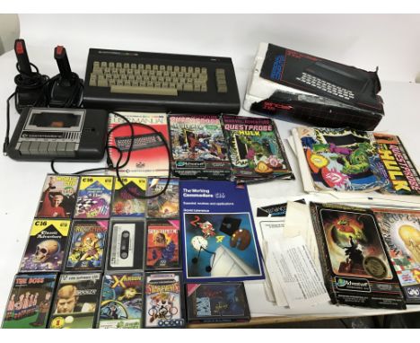 A box containing vintage computer consoles including Sinclair Spectrum ZX81 ad a Commadore 16 wit games and instruction manua