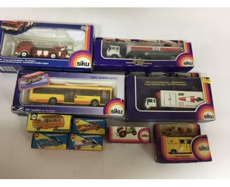 A collection of boxed Siku Diecast vehicles including Fire engine, ESSO petrol tanker, Urban bus, Refrigerated lorry, post va